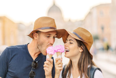 Happy couple eating ice cream in rome, italy. beautiful bright ice cream 