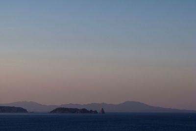 Scenic view of sea against clear sky at sunset