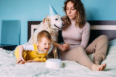 Labrador golden retriever with little child celebrate birthday with cake