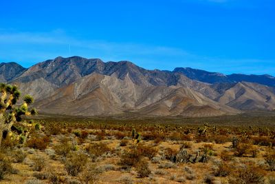 View of mountain range against blue sky