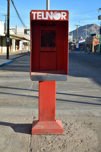 Close-up of telephone booth against the sky