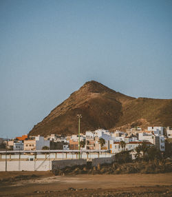 Houses and buildings against clear sky