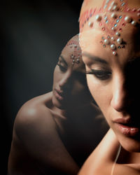 Double exposure of beautiful woman against black background