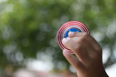 Close-up of hand holding multi colored umbrella