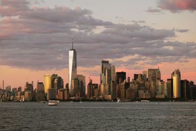 Downtown manhattan skyline with one world trade center at sunset 