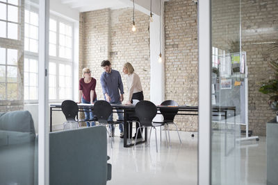 Mature businesswoman working with younger colleagues in office