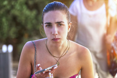 Portrait of young woman standing outdoors