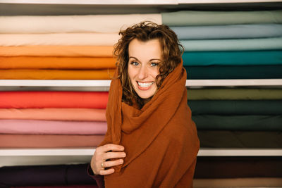 Capturing a whimsical moment, this fashion designer wraps herself in a cozy, terracotta fabric