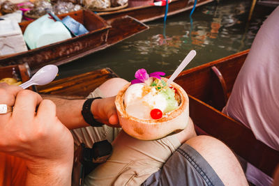 Midsection of man holding ice cream