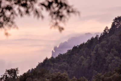 Scenic view of mountains against cloudy sky