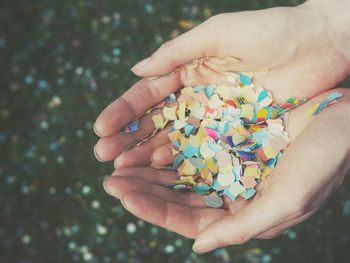 Midsection of person holding multi colored candies