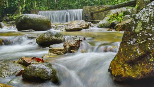 Scenic view of waterfall in river