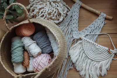 Flatley of products from macrame threads on a wooden background