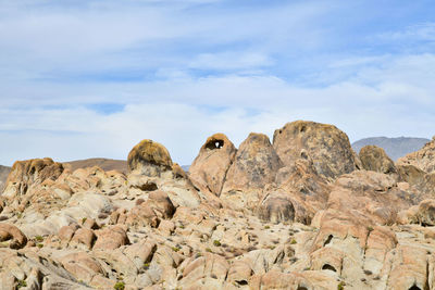 Rock formations on landscape against sky