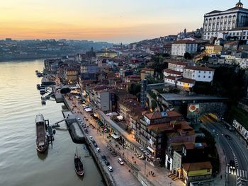 Old town porto view from the bridge. medieval ribeira, boats and douro river. sunset, twilight 
