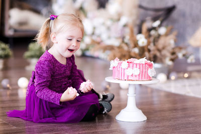 Cute girl eating cake at home