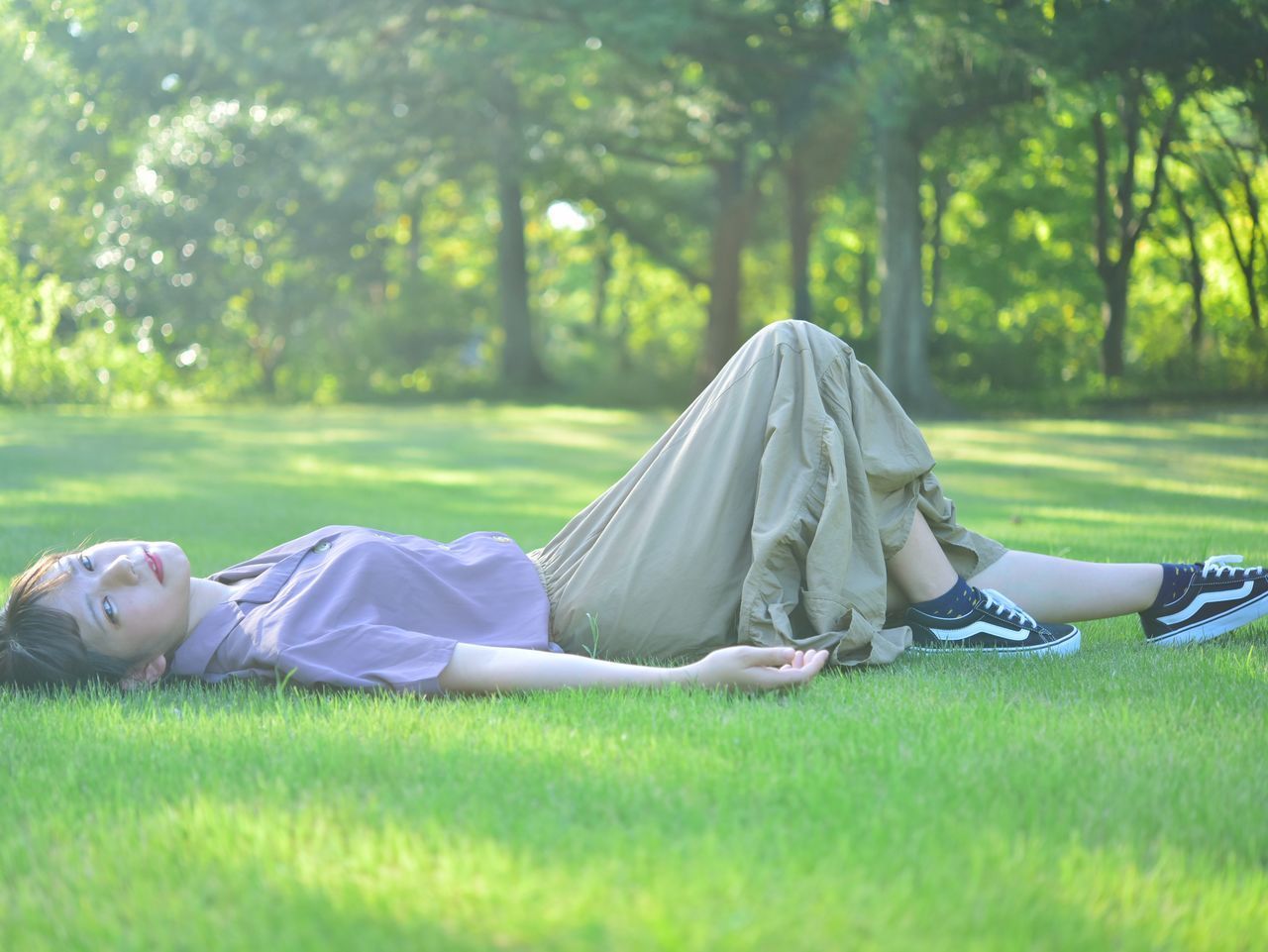 WOMAN LYING ON GRASS