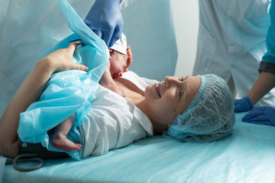 High angle view of doctor examining patient in hospital