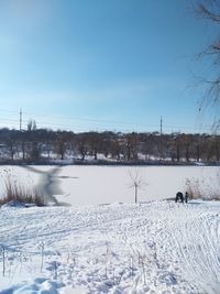 Scenic view of snow covered field against sky