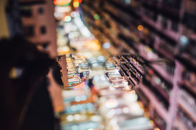 Illuminated street market seen through eyeglasses