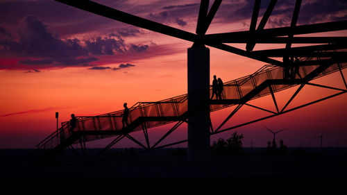 Silhouettes on viewing platform tetraeder in bottrop, germany at sunset