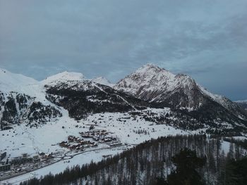 Scenic view of snowcapped mountains against sky