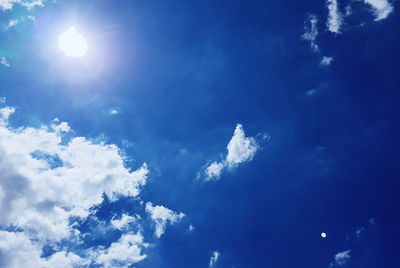 Low angle view of blue sky on sunny day