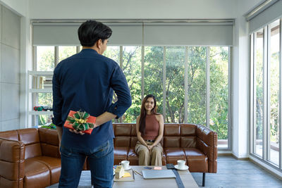 Rear view of couple standing on table
