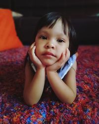 Portrait of cute girl relaxing on bed