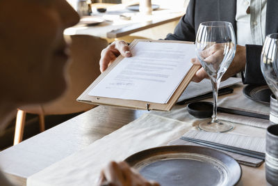 Businessman showing contract in meeting at restaurant