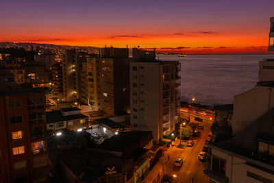 High angle view of illuminated buildings against sky at sunset