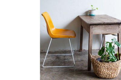 Empty chairs and table against wall at home