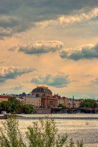  prague national theather from a distance under clouds on a sunny day of summer