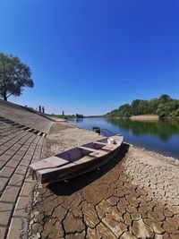 Scenic view of lake against clear blue sky