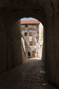 Empty alley amidst buildings in city