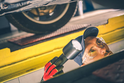 Close-up of mechanic working at auto repair shop