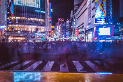 Illuminated city street at night