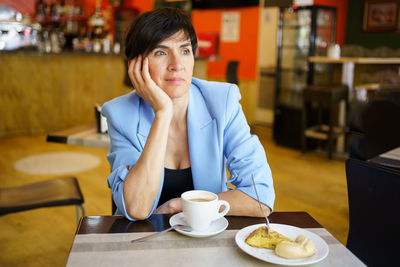 Portrait of young woman having breakfast