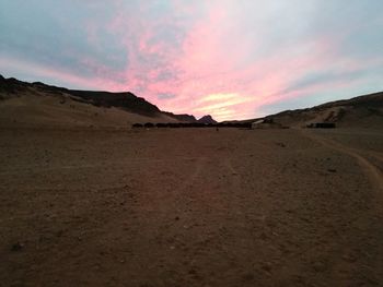 Scenic view of desert against sky during sunset