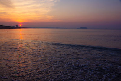 Scenic view of sea against romantic sky at sunset