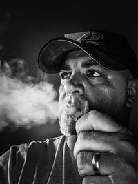 Portrait of man smoking vape 