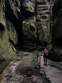 Rear view of woman standing on rock