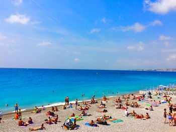 People on beach against sky