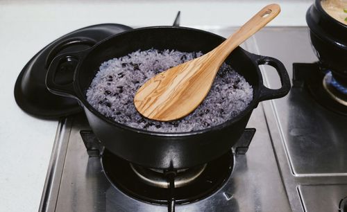 High angel view of food in utensil on gas stove