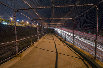 Covered walkway by light trails at night