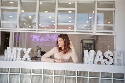 Young woman standing at store