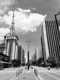 City street and buildings against sky