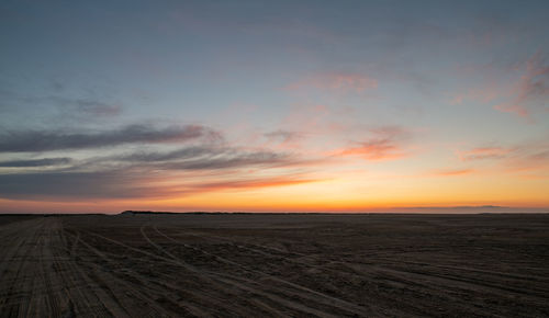 Scenic view of land against sky during sunset