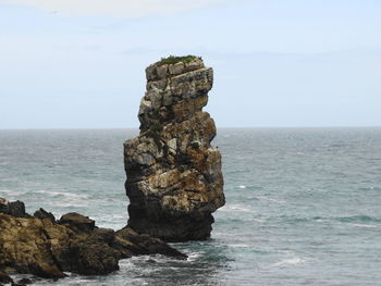 Stack of rock on beach against sky