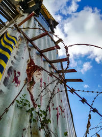 Low angle view of barbed wire against sky